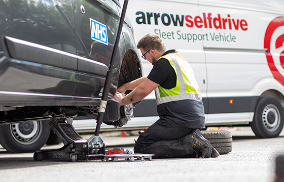 Arrow Self Drive mechanic changing wheel